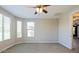 Bright, spacious bedroom with neutral carpet, ceiling fan, and large windows allowing natural light at 3386 E Strawberry Dr, Gilbert, AZ 85298