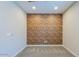 Cozy bedroom featuring a unique brick accent wall, soft carpet, and recessed lighting at 3386 E Strawberry Dr, Gilbert, AZ 85298