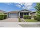 Charming single-story home featuring a well-manicured lawn and an attached two-car garage at 3386 E Strawberry Dr, Gilbert, AZ 85298