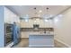 Modern kitchen boasts white cabinets, stainless steel appliances, and a center island at 3386 E Strawberry Dr, Gilbert, AZ 85298