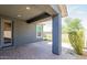 Covered patio with brick flooring, a sturdy support column, and access to the backyard at 3386 E Strawberry Dr, Gilbert, AZ 85298