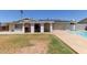 Backyard with a covered patio, barbecue area, and lush green lawn, perfect for outdoor entertaining at 3411 W Redfield Rd, Phoenix, AZ 85053