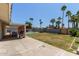 Expansive backyard featuring a pool, lush lawn, and covered patio area at 3411 W Redfield Rd, Phoenix, AZ 85053