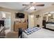 Bedroom showcasing a ceiling fan, dresser with decor, and ensuite bathroom access at 3411 W Redfield Rd, Phoenix, AZ 85053