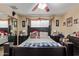 Comfortable bedroom with a ceiling fan, dark wood furniture, and a cozy atmosphere for relaxation at 3411 W Redfield Rd, Phoenix, AZ 85053
