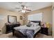 Bedroom featuring a cozy bed, ceiling fan, and bedside tables, creating a comfortable and inviting space at 3411 W Redfield Rd, Phoenix, AZ 85053