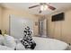 Bedroom featuring a ceiling fan, white comforter, and a closet at 3411 W Redfield Rd, Phoenix, AZ 85053