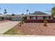 Charming single-story home with a garage, complemented by a well-manicured front yard and landscaping at 3411 W Redfield Rd, Phoenix, AZ 85053