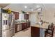 Well-equipped kitchen featuring stainless steel appliances, wood cabinets, and a convenient breakfast bar at 3411 W Redfield Rd, Phoenix, AZ 85053