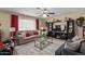 Cozy living room with ceiling fan, an entertainment center, and glass coffee table at 3411 W Redfield Rd, Phoenix, AZ 85053