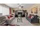 Cozy living room featuring plush sofas, stylish decor, and a ceiling fan at 3411 W Redfield Rd, Phoenix, AZ 85053