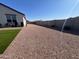 Backyard view with block wall, low-maintenance landscaping, and seating area at 36204 W San Sisto Ave, Maricopa, AZ 85138