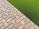 Landscaping featuring a paved patio area and synthetic grass at 36204 W San Sisto Ave, Maricopa, AZ 85138