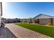 Backyard features brick-paved patio, low-maintenance turf, and block wall at 36204 W San Sisto Ave, Maricopa, AZ 85138