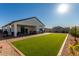 Spacious backyard boasting brick patio, artificial turf, and low maintenance yard at 36204 W San Sisto Ave, Maricopa, AZ 85138