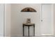 Inviting entryway with decorative table, clock, and wall art, complemented by neutral wall and door colors at 36204 W San Sisto Ave, Maricopa, AZ 85138
