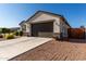 Single-story house with a brown garage door and easy to care for desert landscaping at 36204 W San Sisto Ave, Maricopa, AZ 85138