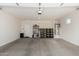 Spacious garage with overhead lighting, a utility sink, and storage shelves at 36204 W San Sisto Ave, Maricopa, AZ 85138