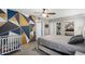 Comfortable bedroom with a bold geometric wall design, a bed, a crib, and closet with mirrored doors at 3732 W Bluefield Ave, Glendale, AZ 85308