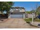 Two-story home with a two-car garage, solar panels, well-maintained landscaping, and a brick facade at 3732 W Bluefield Ave, Glendale, AZ 85308