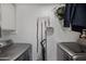 Convenient laundry room featuring modern appliances, hanging rack, and storage options at 3732 W Bluefield Ave, Glendale, AZ 85308