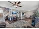 Open-concept living area with fireplace, television, breakfast bar, and staircase for flexible living at 3732 W Bluefield Ave, Glendale, AZ 85308