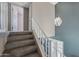 Stairway featuring carpeted steps, white railing, stylish lighting, and view of the lower level at 3732 W Bluefield Ave, Glendale, AZ 85308