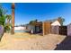 Large backyard with grass, gravel, covered patio and fencing at 3828 W Crocus Dr, Phoenix, AZ 85053