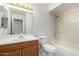 Bathroom with wood vanity, mirror, toilet and bathtub with shower at 3828 W Crocus Dr, Phoenix, AZ 85053