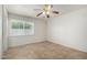 Bright bedroom with a ceiling fan, a large window, and tile floors at 3828 W Crocus Dr, Phoenix, AZ 85053