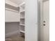 Walk-in closet featuring shelving and a door at 3828 W Crocus Dr, Phoenix, AZ 85053