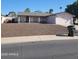 Single-story home with a two-car garage and low-maintenance landscaping in front at 3828 W Crocus Dr, Phoenix, AZ 85053