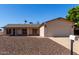 Charming home with a two-car garage, neutral colors and low-maintenance gravel landscaping in front at 3828 W Crocus Dr, Phoenix, AZ 85053