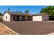 Attractive single-Gathering home featuring a two-car garage and low-maintenance rock landscaping at 3828 W Crocus Dr, Phoenix, AZ 85053