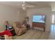Spacious living room with a ceiling fan, and view of a wall-mounted television at 3828 W Crocus Dr, Phoenix, AZ 85053