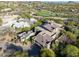 An aerial view showcases a home surrounded by lush desert landscape and a nearby green golf course at 39541 N 107Th Way, Scottsdale, AZ 85262