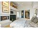 Well-lit bedroom with a fireplace, TV, and access to an en-suite bathroom and ample storage space at 39541 N 107Th Way, Scottsdale, AZ 85262