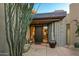 Inviting front entrance features a custom door, desert landscaping, and a peaceful water feature at 39541 N 107Th Way, Scottsdale, AZ 85262
