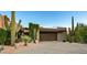 Contemporary home with desert landscaping, a paved driveway, and an attached two-car garage at 39541 N 107Th Way, Scottsdale, AZ 85262