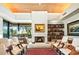 Cozy living room with a fireplace, built-in bookshelves, and large windows for natural light at 39541 N 107Th Way, Scottsdale, AZ 85262