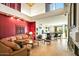 Spacious living room with an adjacent kitchen, fireplace and views of the yard and mature landscaping at 39541 N 107Th Way, Scottsdale, AZ 85262