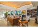 Bright and open living area with vaulted ceilings, fireplace, built-in bookshelves and view of the dining area at 39541 N 107Th Way, Scottsdale, AZ 85262