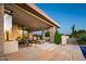 Relaxing outdoor patio with dining and lounge seating, perfect for enjoying the desert landscape near a refreshing pool at 39541 N 107Th Way, Scottsdale, AZ 85262