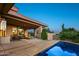 Inviting outdoor space with a covered patio, dining area, lounge chairs, and a refreshing pool next to desert landscape at 39541 N 107Th Way, Scottsdale, AZ 85262