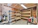 Unfinished basement with shelving, concrete floors, and a hot water heater at 4034 E Aster Dr, Phoenix, AZ 85032