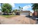 Inviting single-story home with a spacious driveway leading to an attached two-car garage at 4034 E Aster Dr, Phoenix, AZ 85032