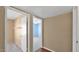 Neutral hallway leads to carpeted bedroom with a ceiling fan and walk-in closet at 4034 E Aster Dr, Phoenix, AZ 85032