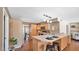 Well-lit kitchen with modern appliances, wooden cabinets, and a convenient breakfast bar at 4034 E Aster Dr, Phoenix, AZ 85032