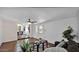 Comfortable living room with wood floors, ceiling fan, and an inviting view into the dining room at 4034 E Aster Dr, Phoenix, AZ 85032