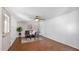 Comfortable living room with hardwood floors, ceiling fan, and neutral paint at 4034 E Aster Dr, Phoenix, AZ 85032